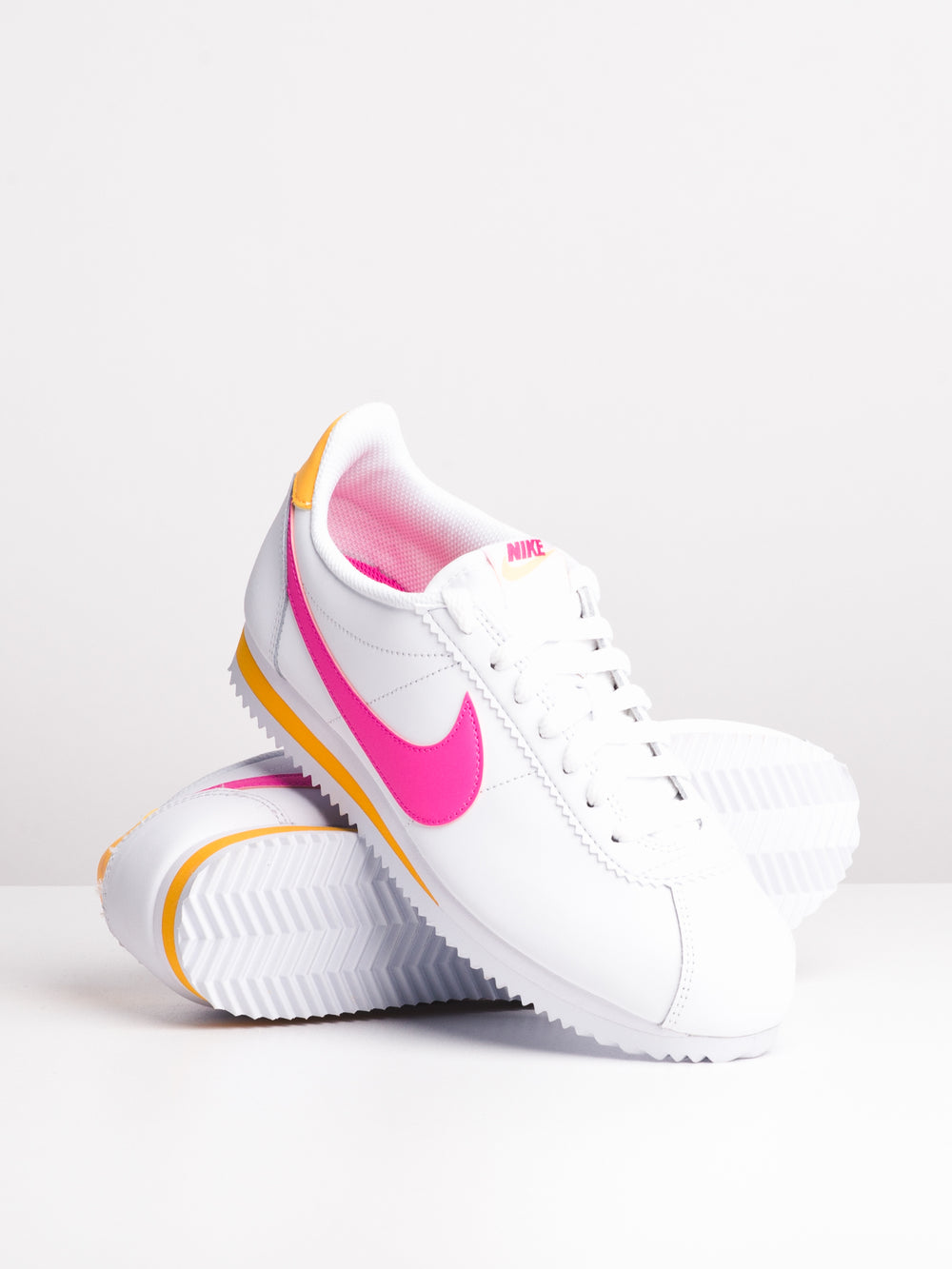 pink and yellow nike cortez