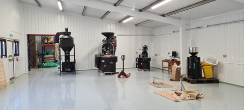 20kg and 3kg coffee roasting machines in a large white factory setting