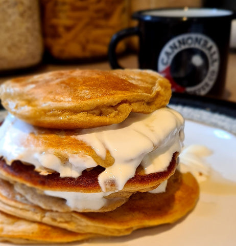 stack of protein pancakes and a cup of cannonball coffee