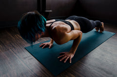 lady doing press-ups on gym mat at home