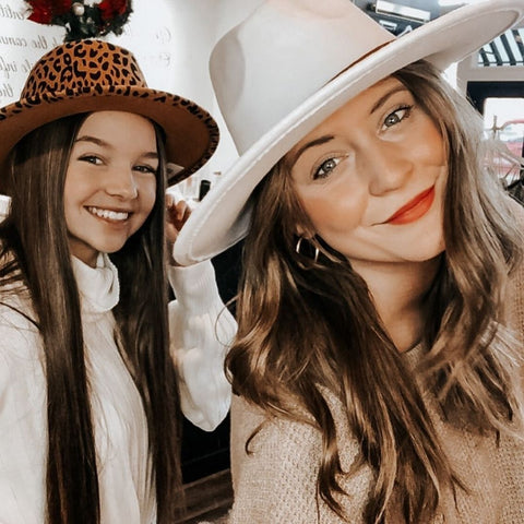 women in designer hats