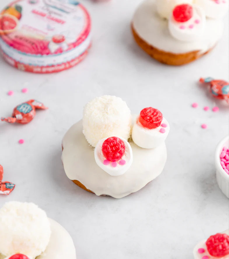 Easter Donuts with white frosting, marshmallows, and Torie & Howard hard candies placed on top to look like a bunny tail and feet