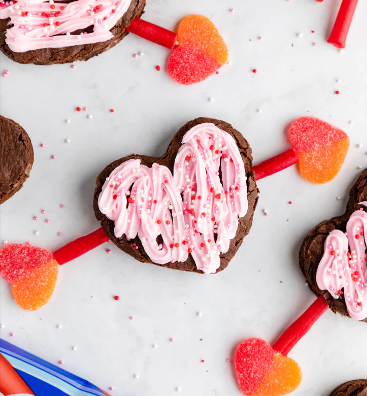 Heart shaped brownie with a Red Vines Red Rope arrow going through it