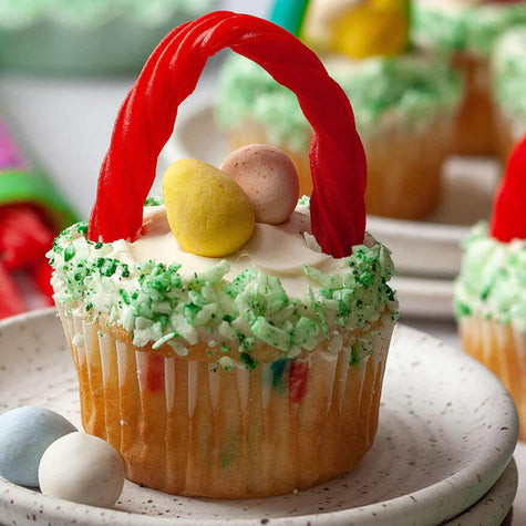 Cupcake made to look like an Easter basket with candy eggs, green coconut 