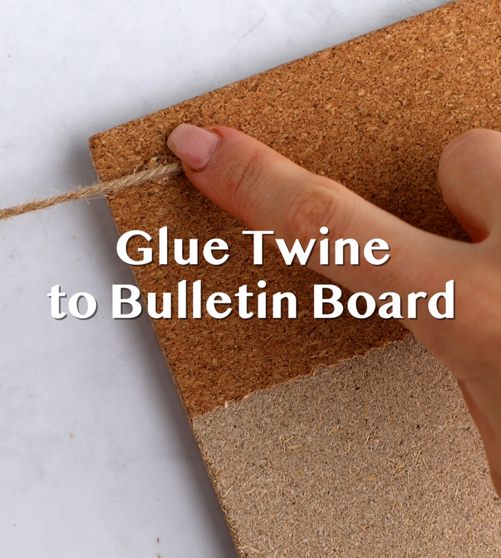 Twine being glued to a bulletin board