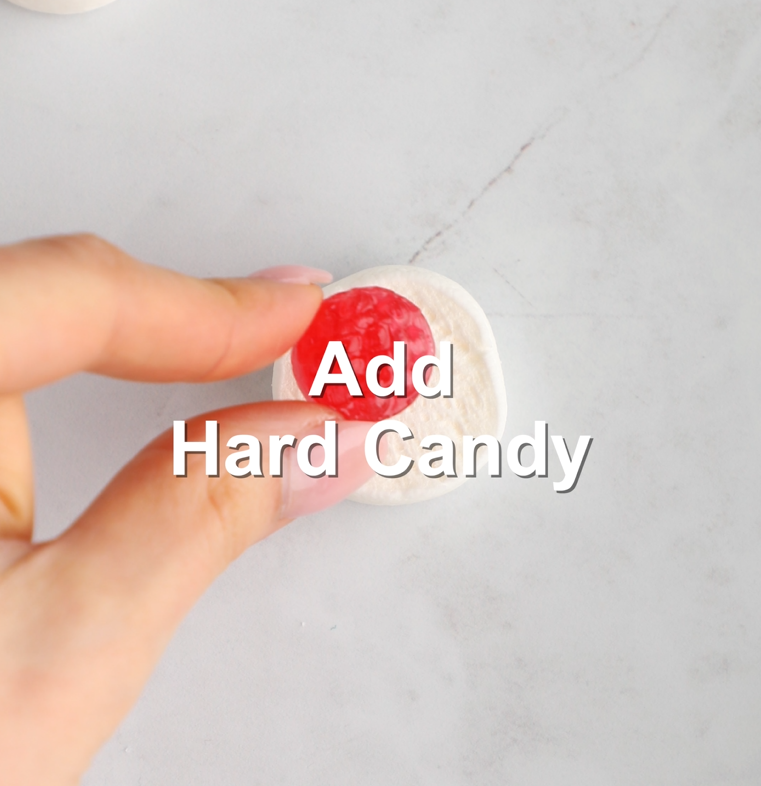 hard candy being placed on top of a marshmallow half