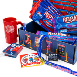 Close up of Red Vines cup, movie trivia, Red Vines Movie Club sticker, and clapperboard keychain that come inside the Movie Lovers Club Box for 2024