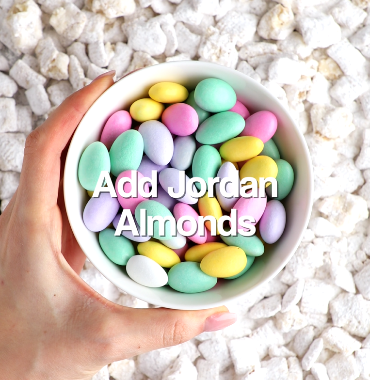 Pastel jordan almonds added to the powdered sugar-coated cereal