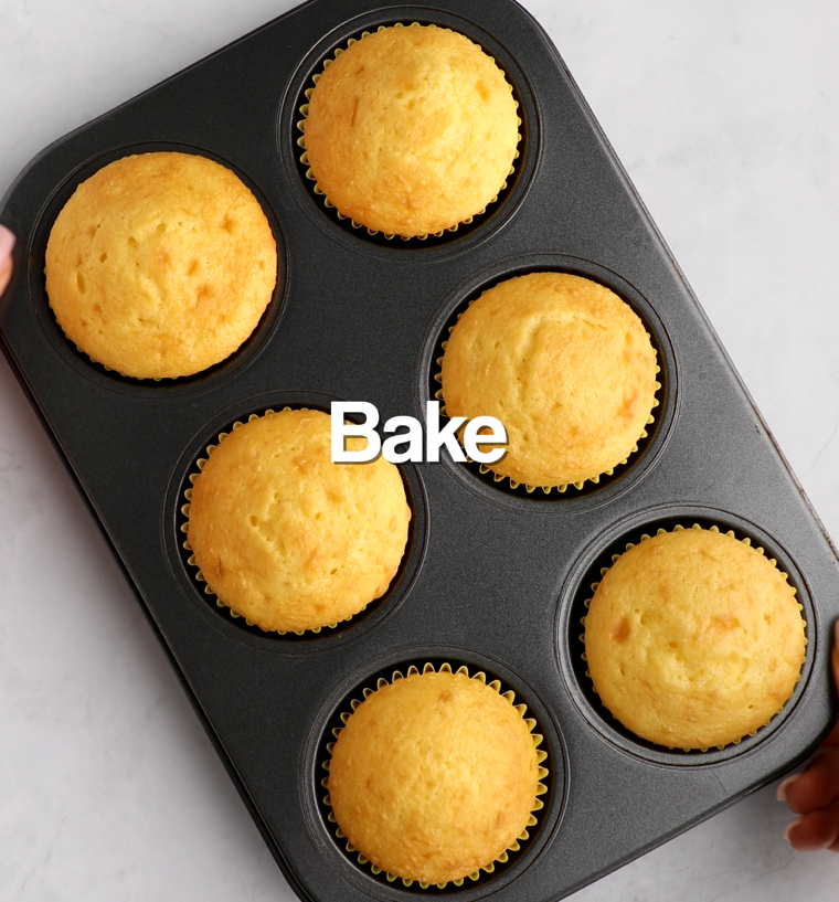 Baked yellow cupcakes in yellow cupcake liners in muffin tin
