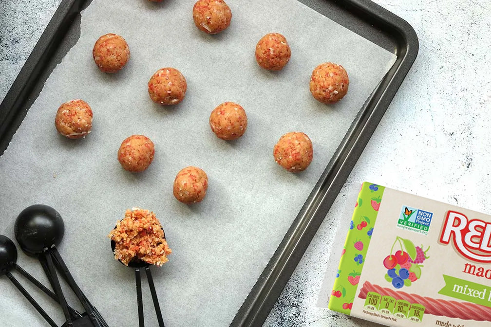 Combined ingredients rolled into small balls on a baking sheet
