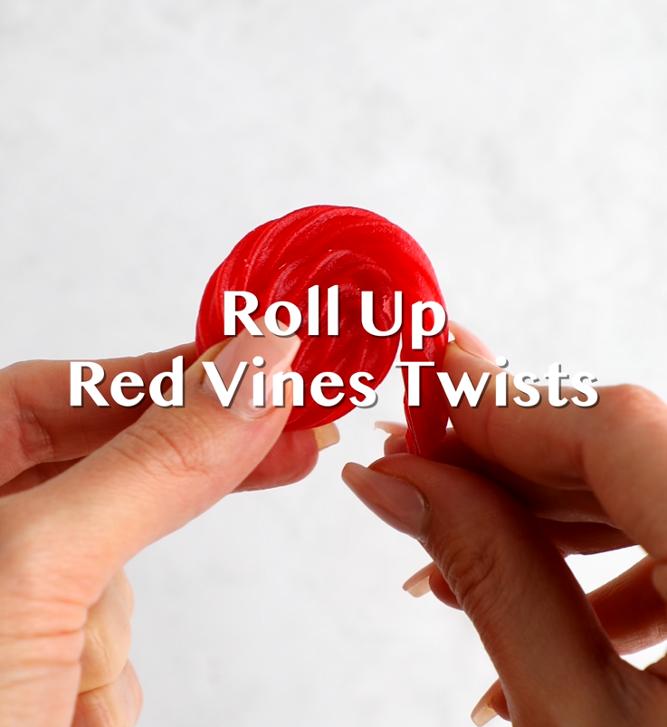 Red Vines Original Red Licorice Twists being rolled into a circle