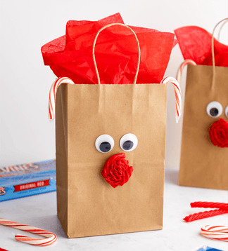 Paper bag reindeer craft with a rolled up Red Vines Original Red Licorice Twist as the nose