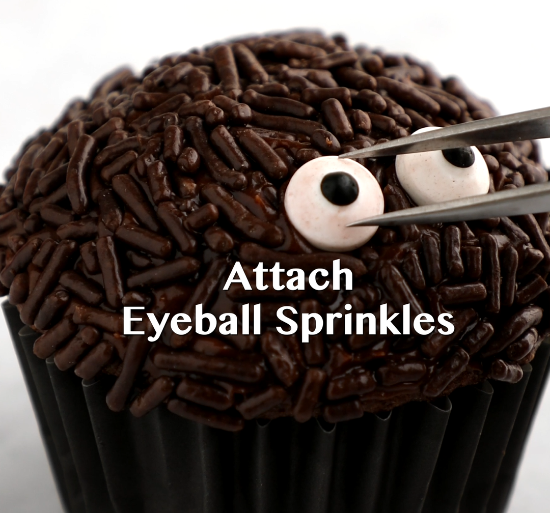 Candy eyeballs placed onto cupcakes