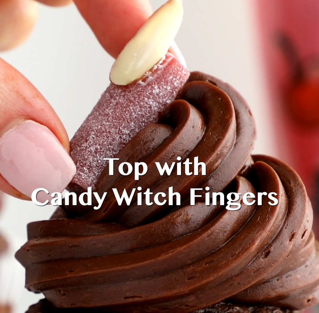 Frosted chocolate cupcakes topped with witch fingers made from Sour Punch Rad Reds Bites candy