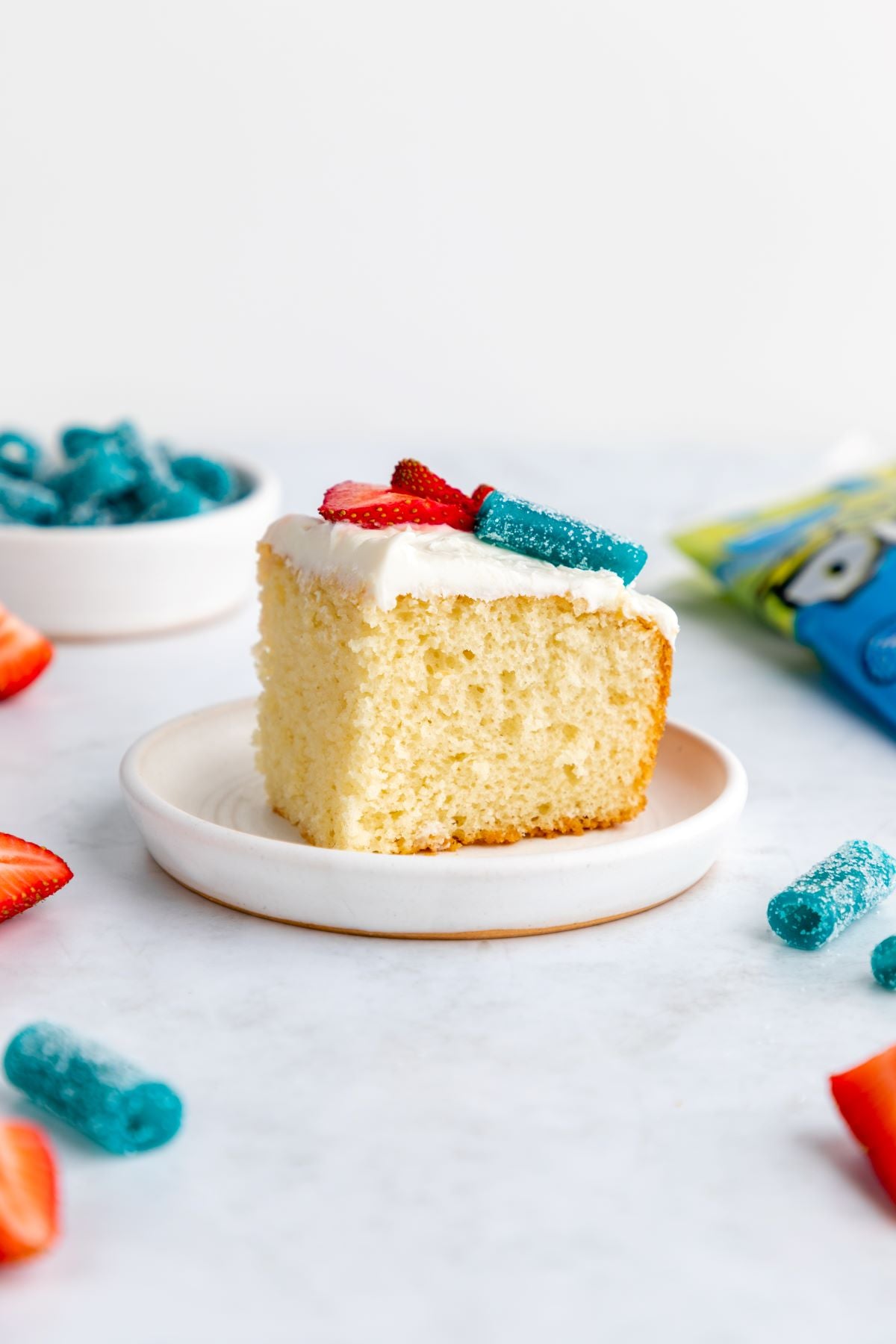 American Flag Cake Recipe with fresh strawberries and Sour Punch Blue Bites Candy