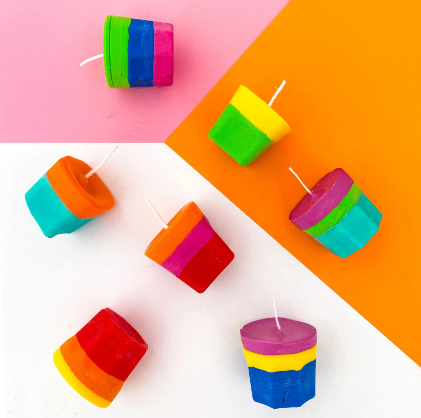 Crayon candles on pink and orange background