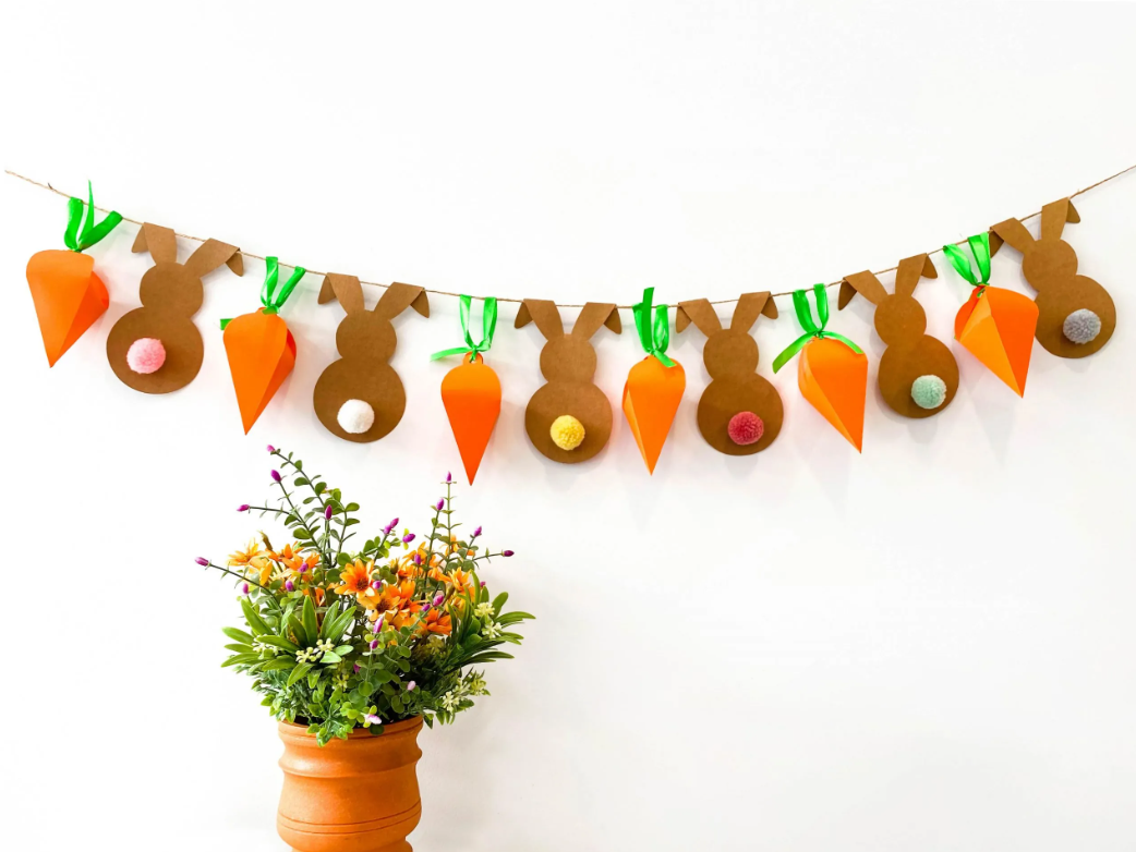 Completed Easter Garland Craft on a wall next to potted plant