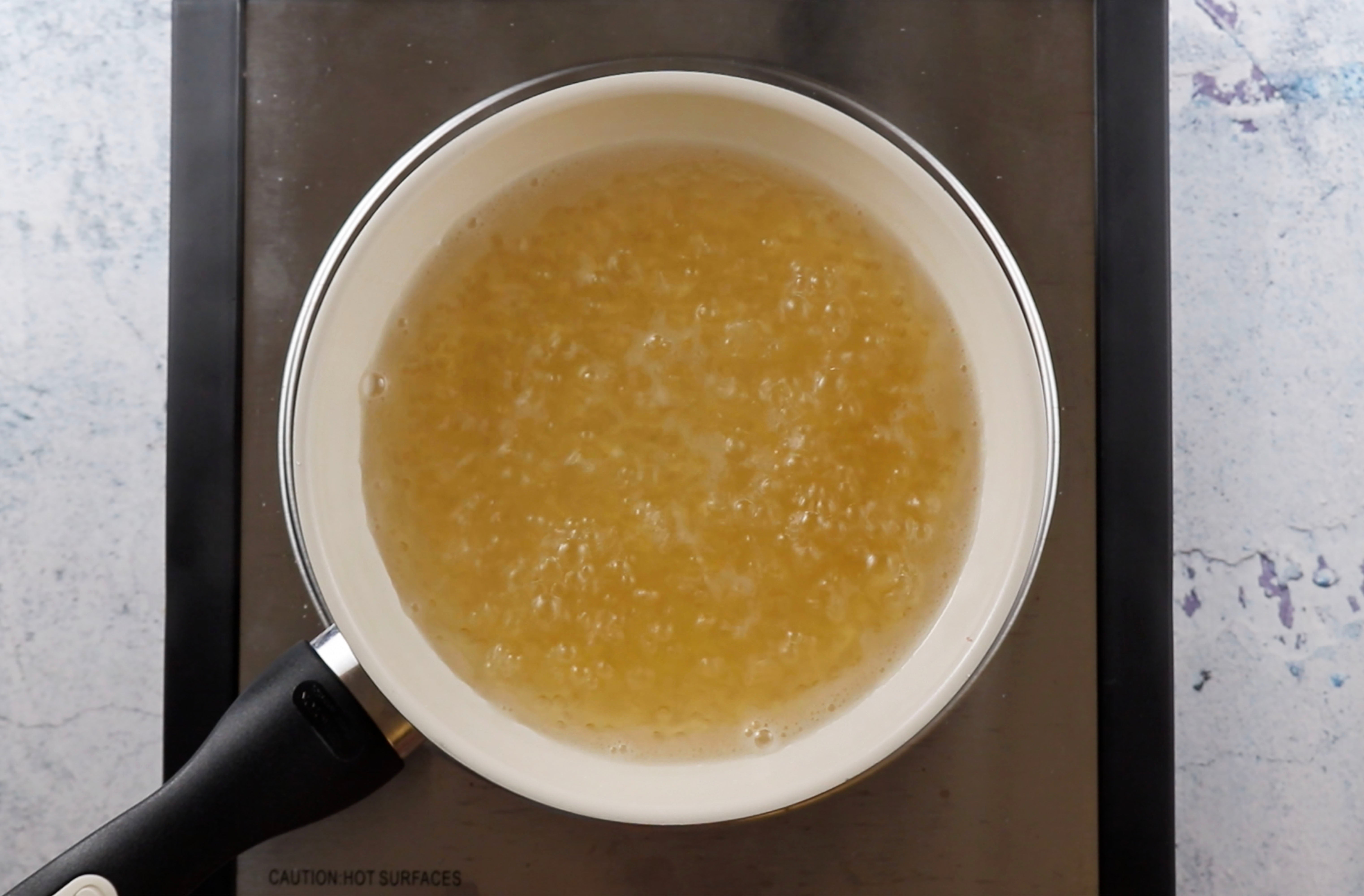 Sugar and water mixture simmering over low heat