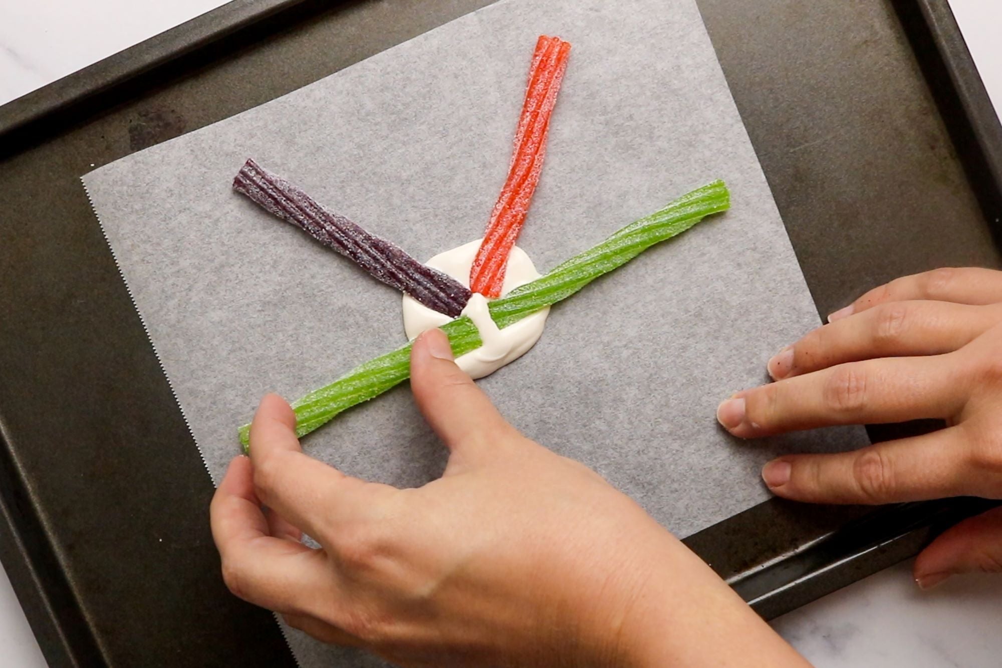 Sour Punch Halloween Twists pressed into melted candy in a spoke-like pattern