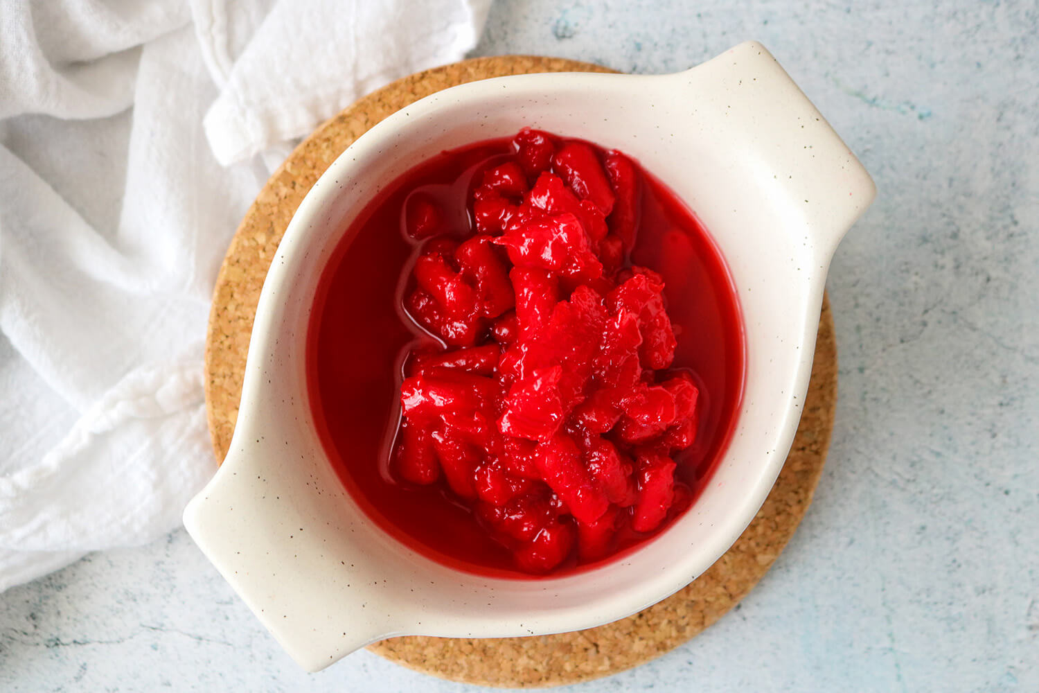 Mixing melted Red Ropes Candy with dissolved sugar