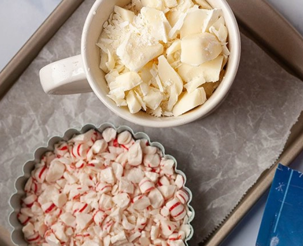 Chopped white chocolate and peppermint candies in two separate dishes