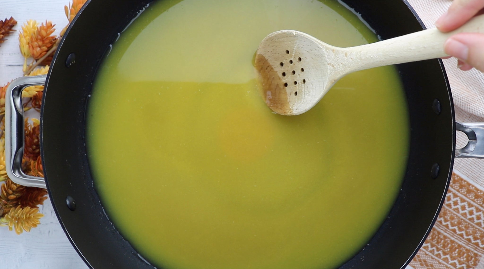 Orange juice, water and sugar simmering in a large skillet