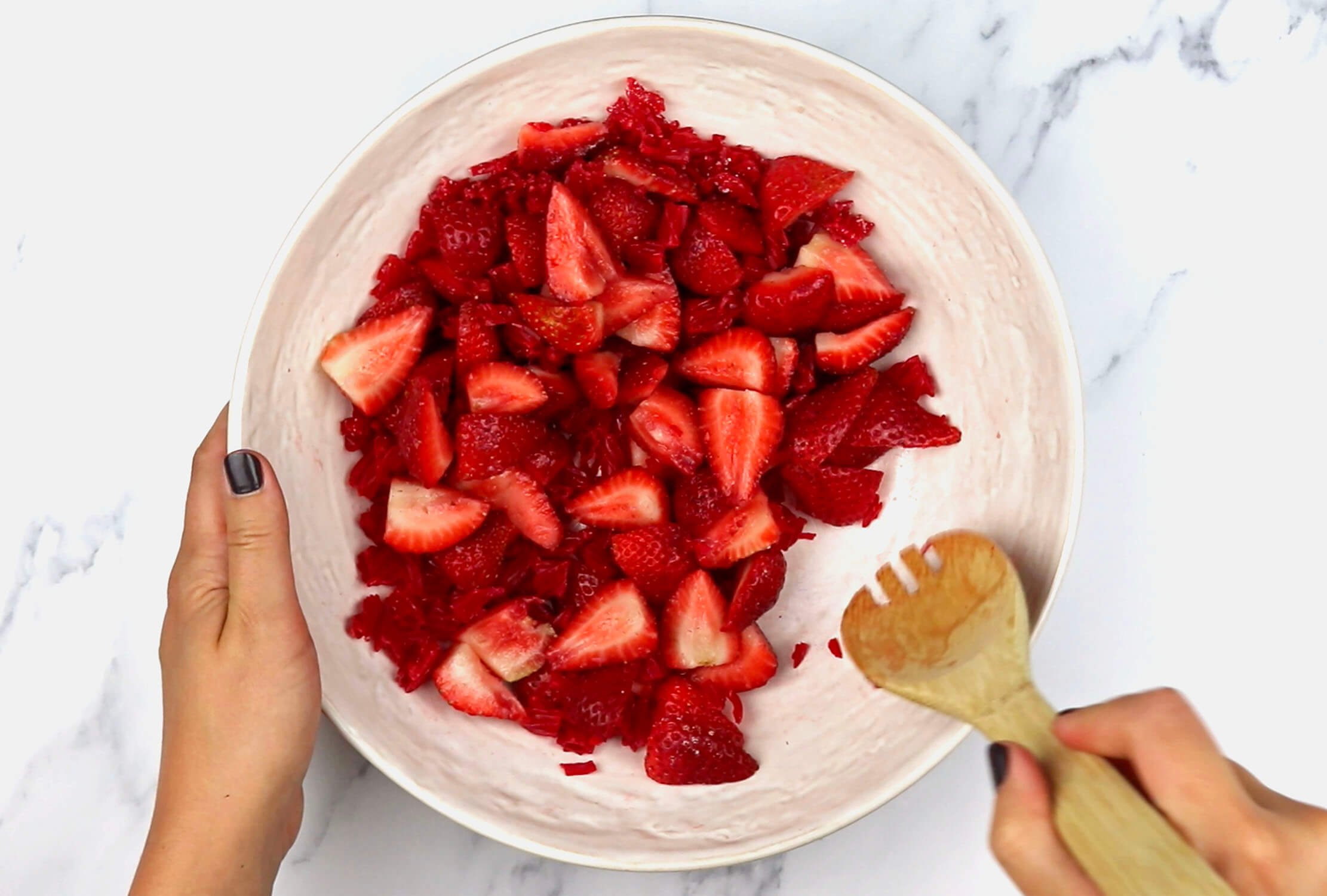 Stirring strawberries, sugar, and Red Vines Sugar Free Licorice