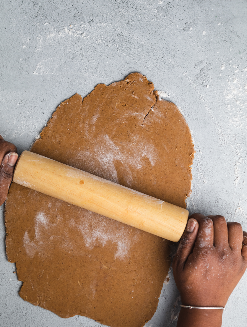 Gingerbread cookie dough being rolled out