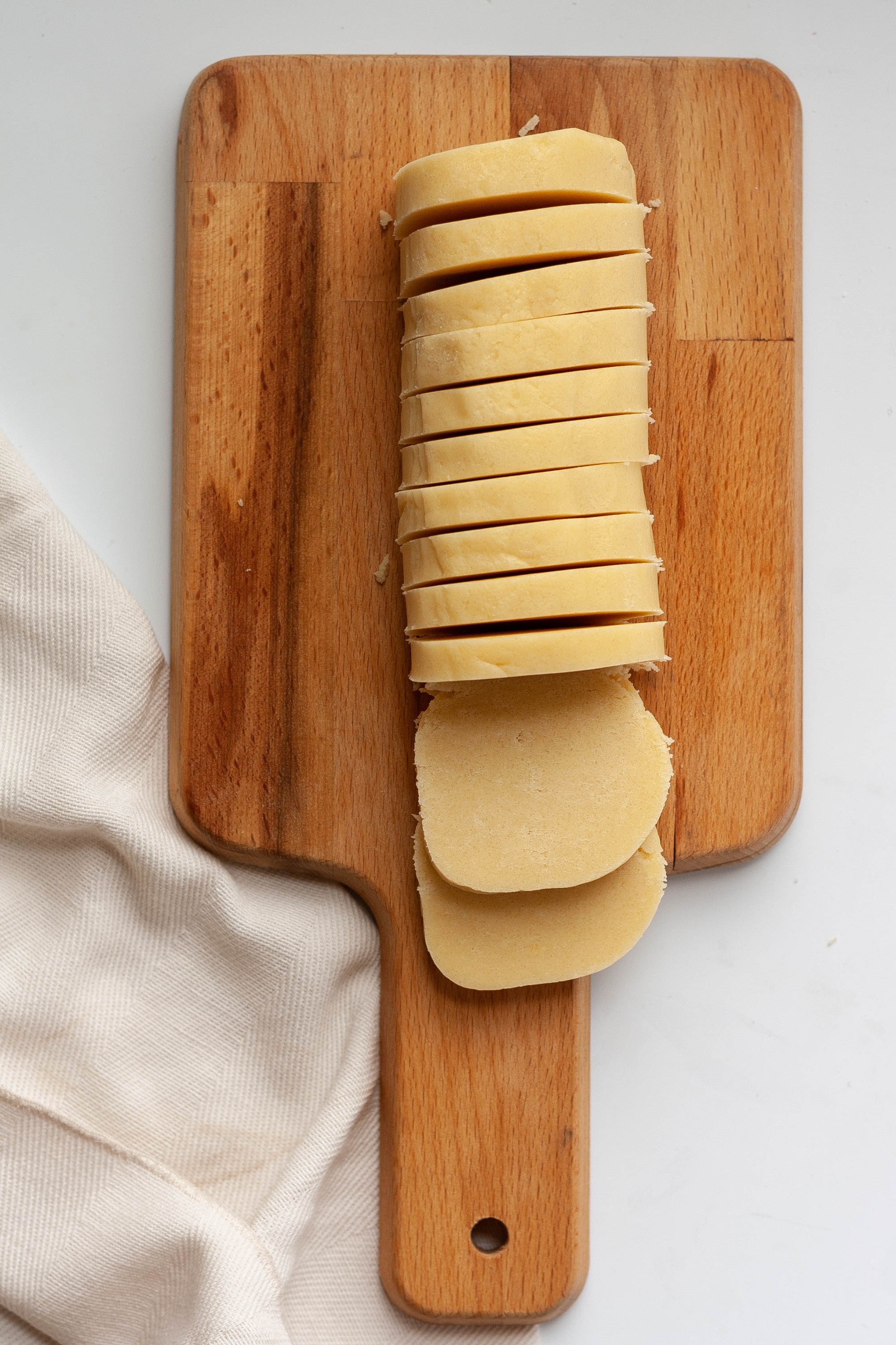 Cookie dough log sliced into rounds