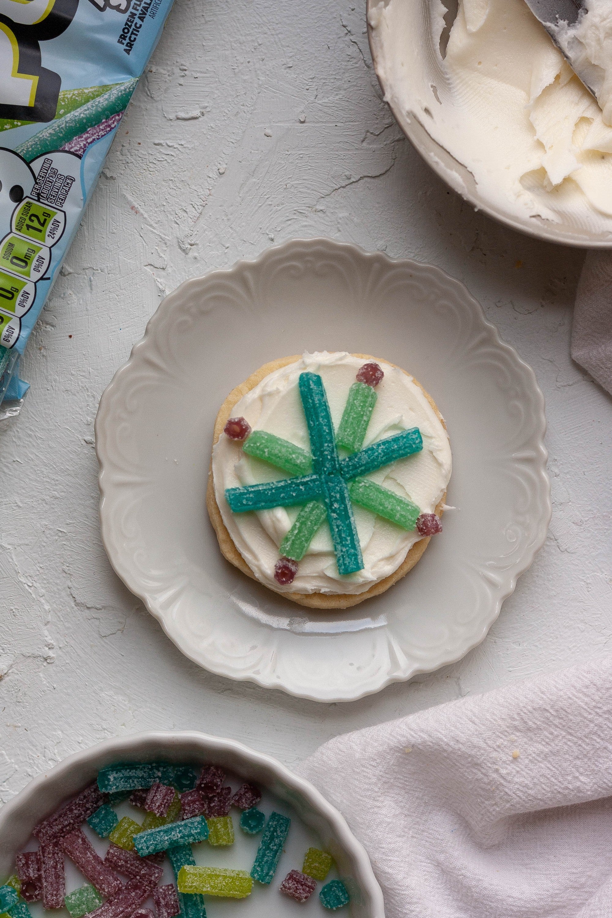 Frosted sugar cookie decorated with Sour Punch Arctic Straws candy