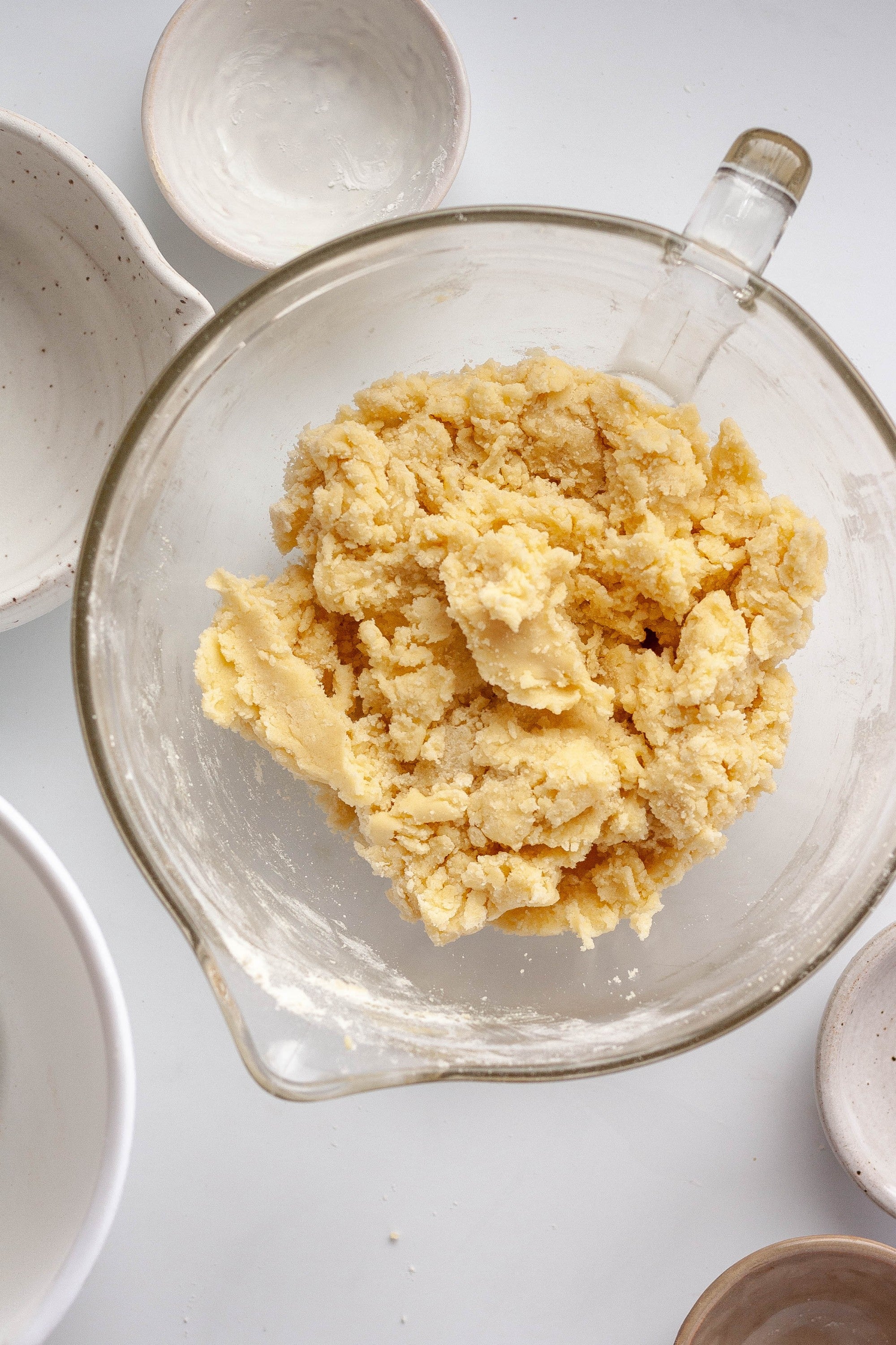 Thicker dough from flour being added to sugar cookie mixture