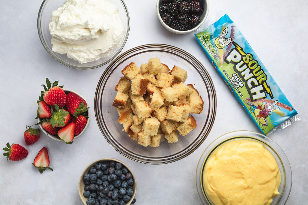 Sour Punch, Cake, Frosting, Pudding, and Berries prepped in bowls