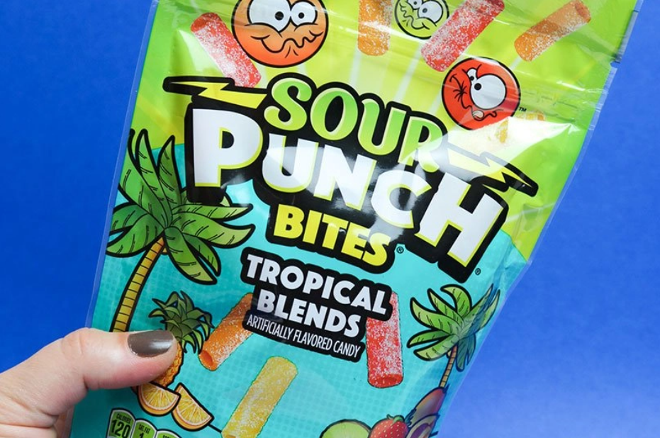 Person holding a bag of Sour Punch Tropical Candy Bites