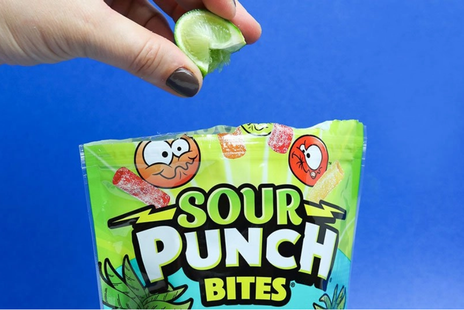 Lime juice being squeezed into bag of candy bites