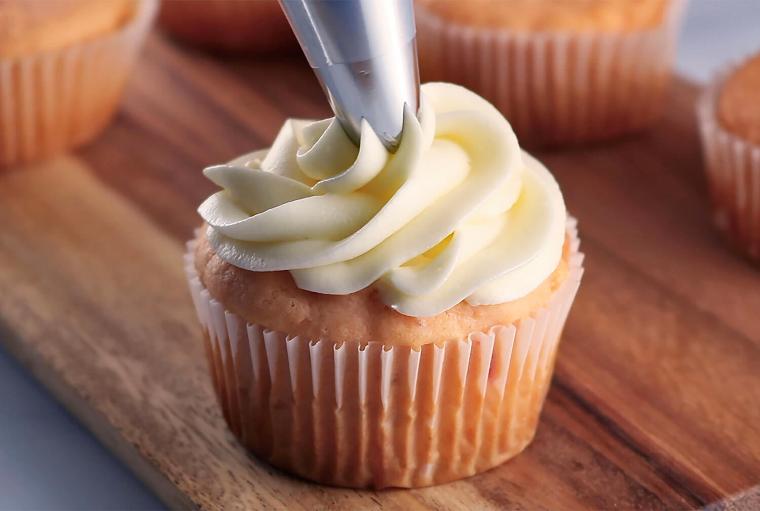 Frosting Pina Colada Cupcakes with White Coconut Cream Cheese Frosting