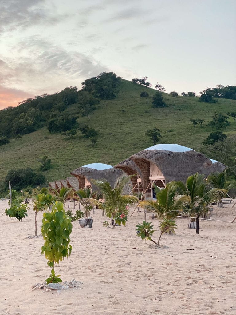 huts on a beach at sunset le pirate flores indonesia