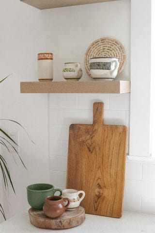 high fire clay pottery mugs on floating kitchen shelf 