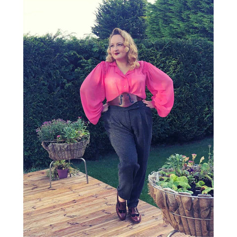 Ms Carnivale wearing a bautiful pink blouse with billowing sleeves made from fabric from Amo Threads