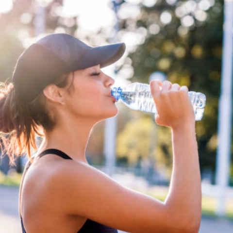 mujer tomando una botella con agua