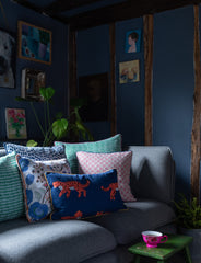 Kitty-Holmes-Dark-room-with-colourful-cushions