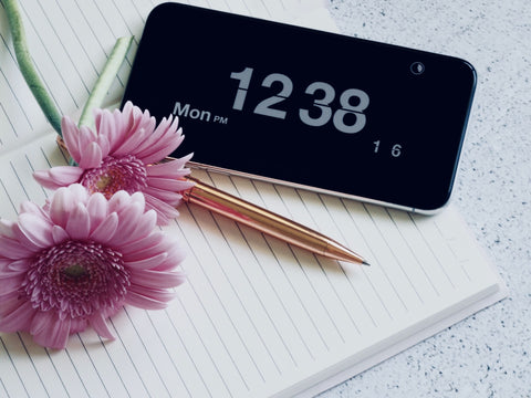 stationary, smartphone, notebook and flowers