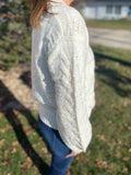 This classic ivory cable knit sweater will never go out of style! This snuggly sweater with a crew neck and textured cable knit lends to a traditional allure.   Product Details:  100% Acrylic Semi-fitted