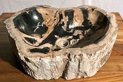 view from above of a petrified wood vessel sink with brown and black colors