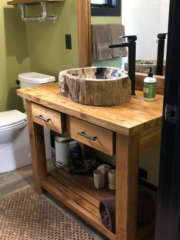 Petrified wood vessel sink installed on a reclaimed teak bathroom vanity in Ketchum, Idaho