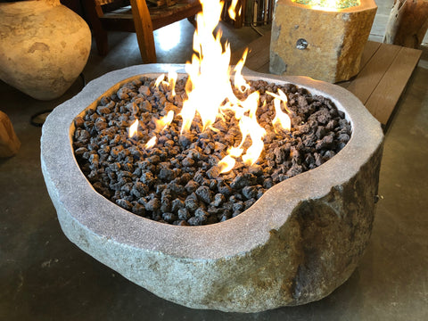 Top view of a burning river boulder gas fire pit showing the unique shape of the stone