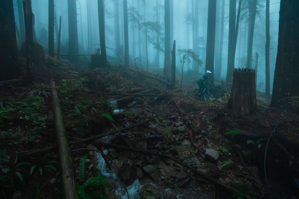 Sam riding through the fog on a North Shore mtb trail