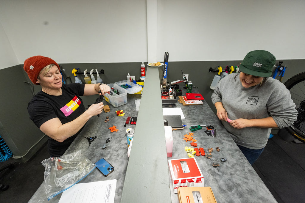 Ash Kelly and Jaime Hill share a bench for a SRAM brake demo