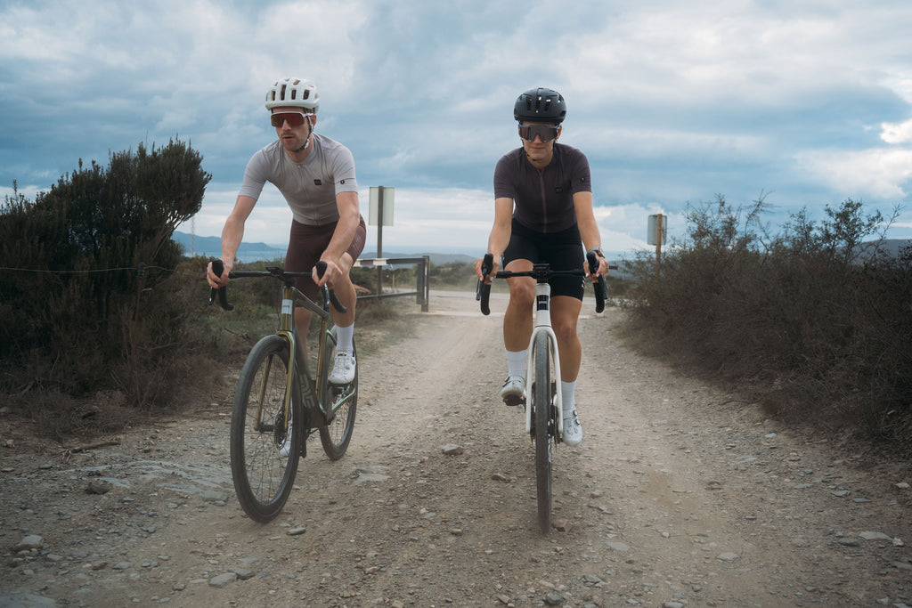 Two riders transfer from asphalt to gravel on the Enve Fray