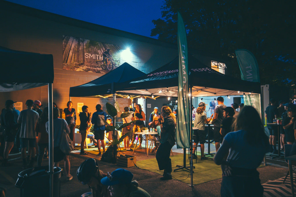 Riders enjoy the apres party under lit tents at night