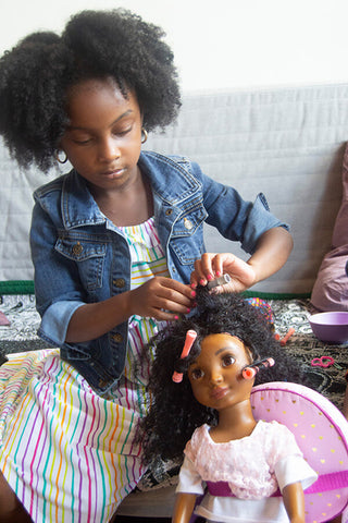 African American Girl playing with doll with naturally curly hair from Healthy Roots Dolls